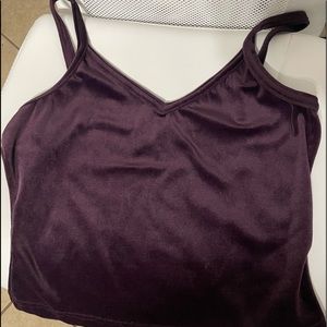 The top is a purple in Medium. the material is velvet. still in good condition